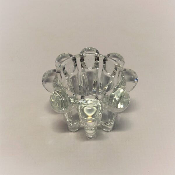 Zems stikla svečturis svecēm.